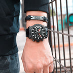 MEGIR 2134 men's chronograph watch on the wrist, black case with black dial and black steel bracelet, close-up
