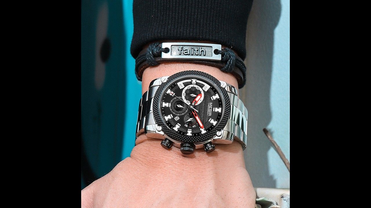 MEGIR 2134 men's chronograph watch on the wrist, silver case with black dial and stainless steel bracelet, close-up