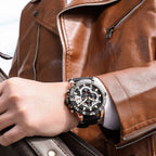 MEGIR 2136 men's chronograph watch on the wrist, rose-gold case with black dial and black leather strap