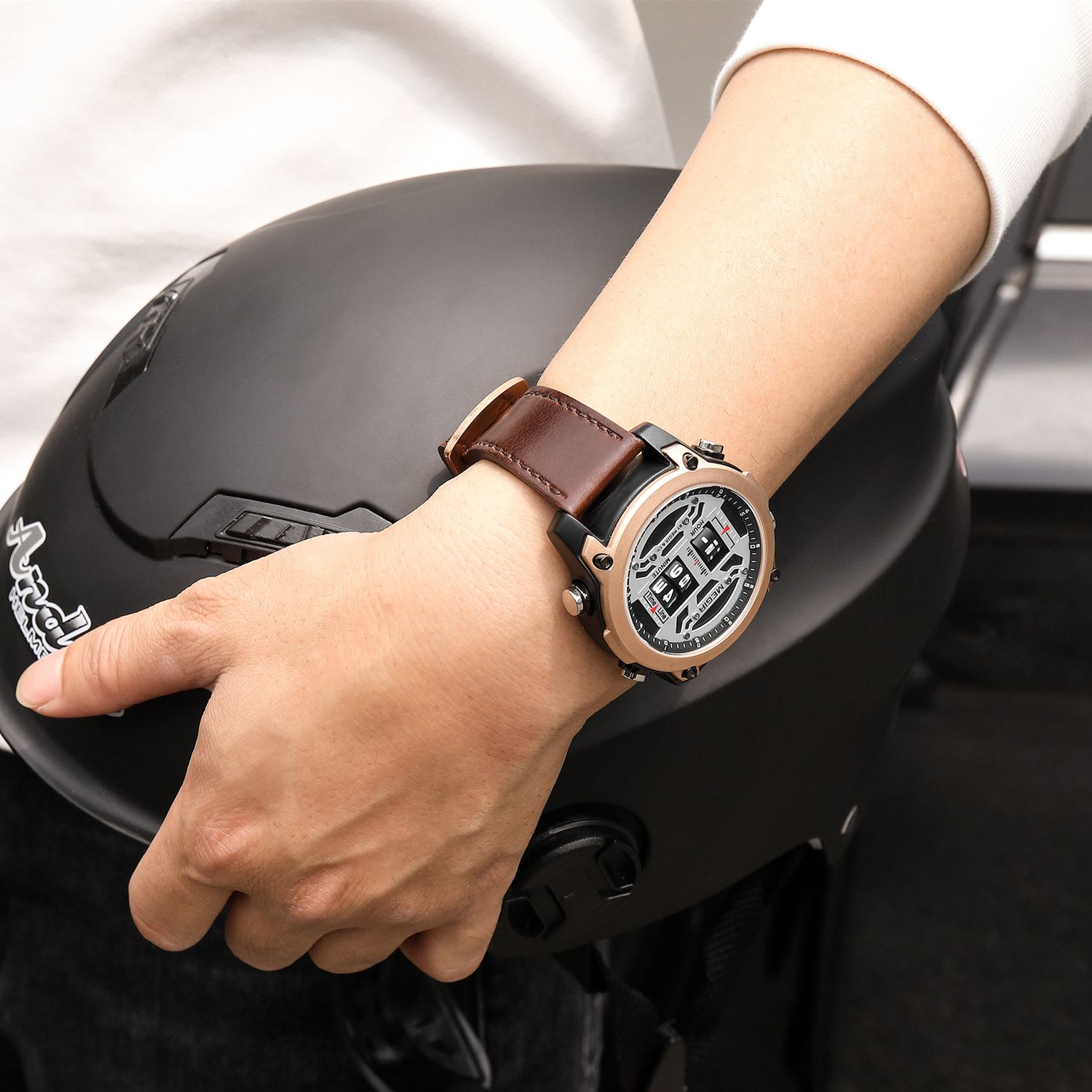 MEGIR 2142 men's sport watch on the wrist, rose-gold case with white roller-barrel dial and brown leather strap, close-up