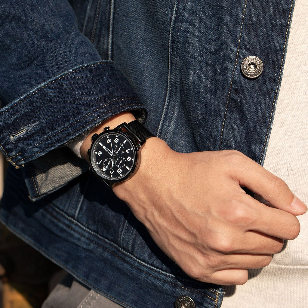 MEGIR 2157 men's chronograph watch on the wrist, black case with black dial and black mesh bracelet