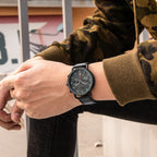 MEGIR 2159 men's chronograph watch on the wrist, black case with grey dial and black leather strap, side view