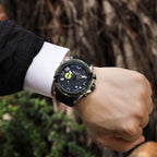 MEGIR 2200 men's chronograph watch on the wrist, silver case with green bezel, black dial and black silicone strap