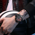 MEGIR 2209 men's chronograph watch on the wrist, black case with red-accent skeleton dial and black silicone strap