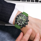 MEGIR 2209 men's chronograph watch on the wrist, black case with green skeleton dial and green silicone strap