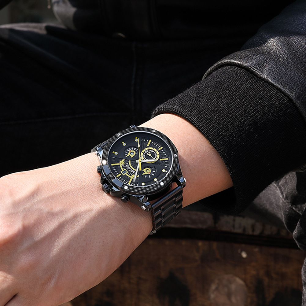 MEGIR 2216 men's chronograph watch on the wrist, black case with gold-accent black dial and black bracelet