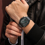 MEGIR 2217 men's chronograph watch on the wrist, black case with green-accent dial and steel bracelet