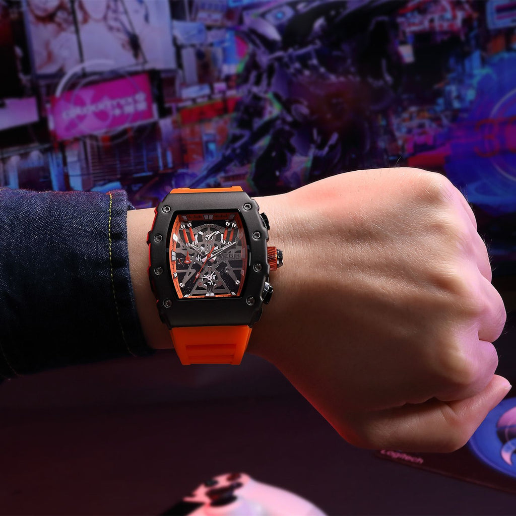 MEGIR 2218 men's skeleton watch on the wrist, black case with orange-accent skeleton dial and orange silicone strap