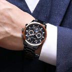 MEGIR 2220 men's chronograph watch on the wrist, black case with rose-gold bezel, black dial and black bracelet