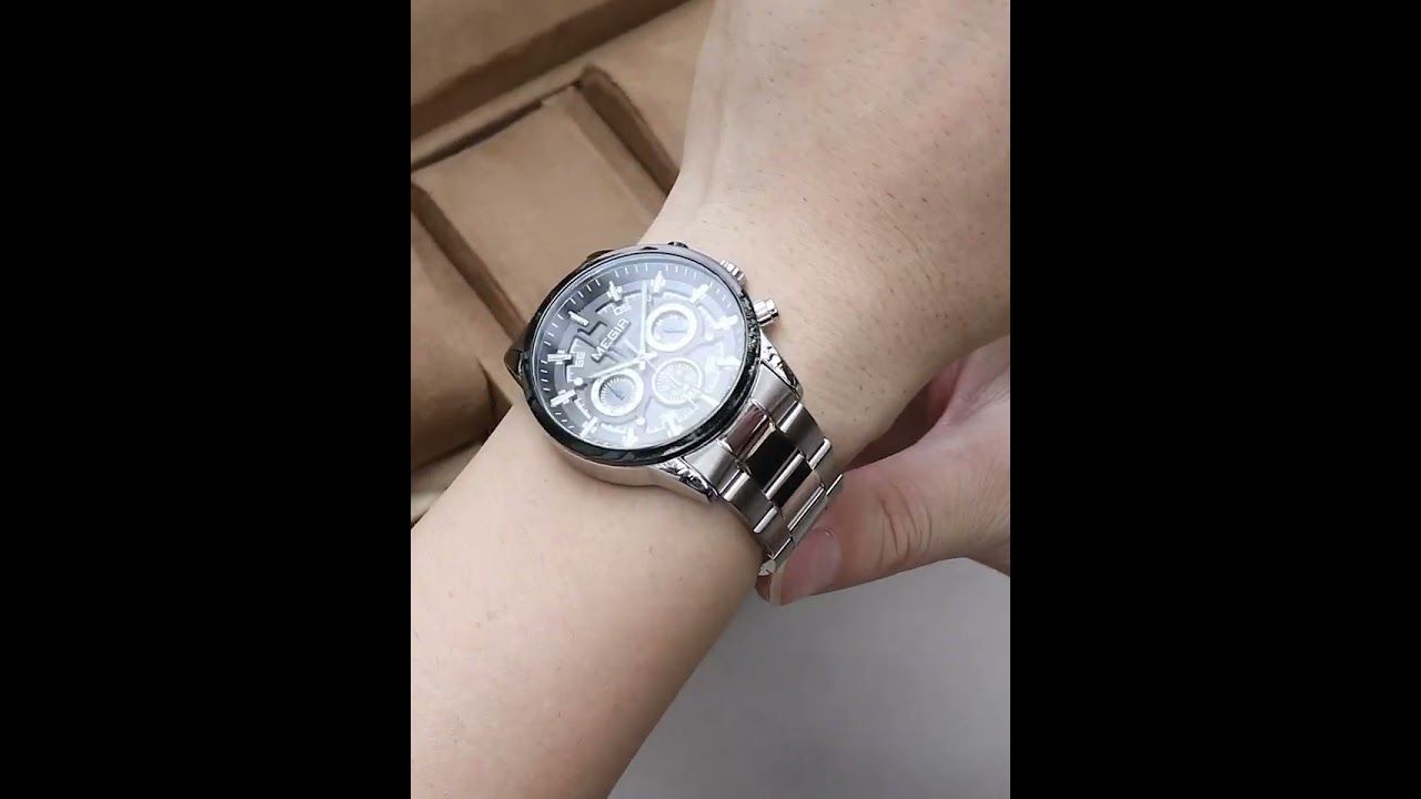 MEGIR 2220 men's chronograph watch on the wrist, steel case and bracelet, held to show the dial