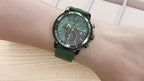 MEGIR 2224 men's chronograph watch on the wrist, black case with green dial and green silicone strap, side angle