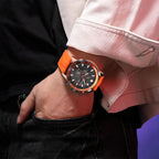 MEGIR 2224 men's chronograph watch on the wrist, rose-gold case with black dial, orange bezel and orange silicone strap