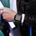 MEGIR 2228 men's chronograph watch on the wrist, black square case with skeleton dial and black silicone strap