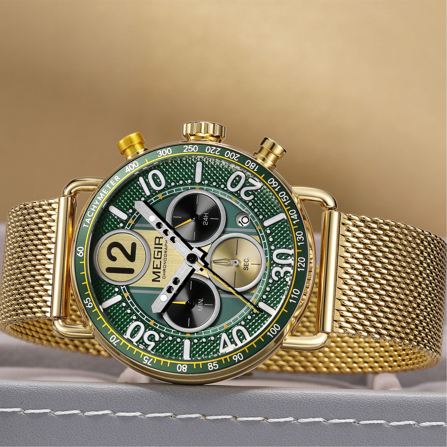 MEGIR 2249 men's chronograph watch, gold-tone case with green dial, tachymeter bezel and gold mesh bracelet, angled view
