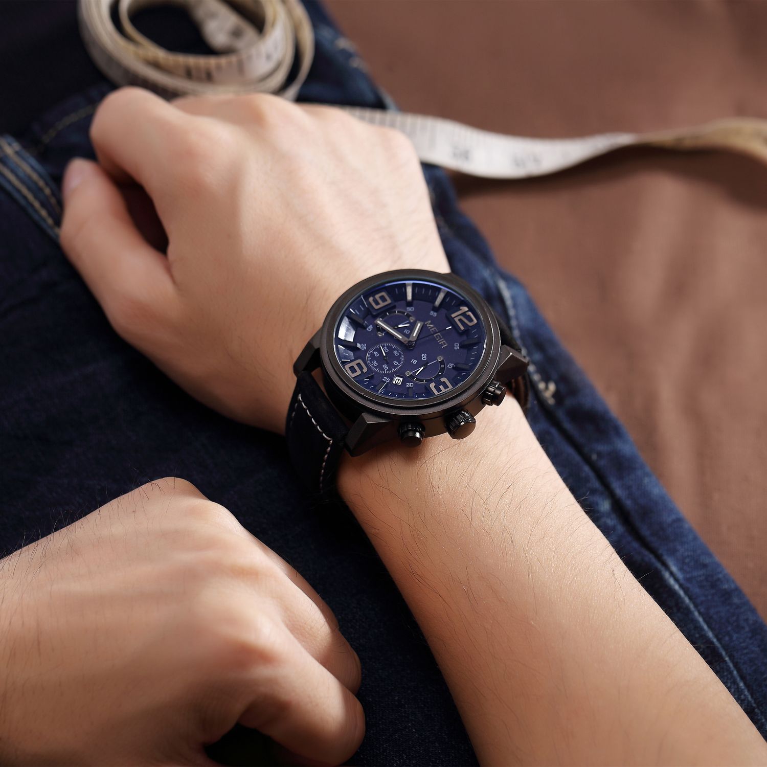 MEGIR 3010 men's chronograph watch on the wrist, black case with blue dial and black leather strap