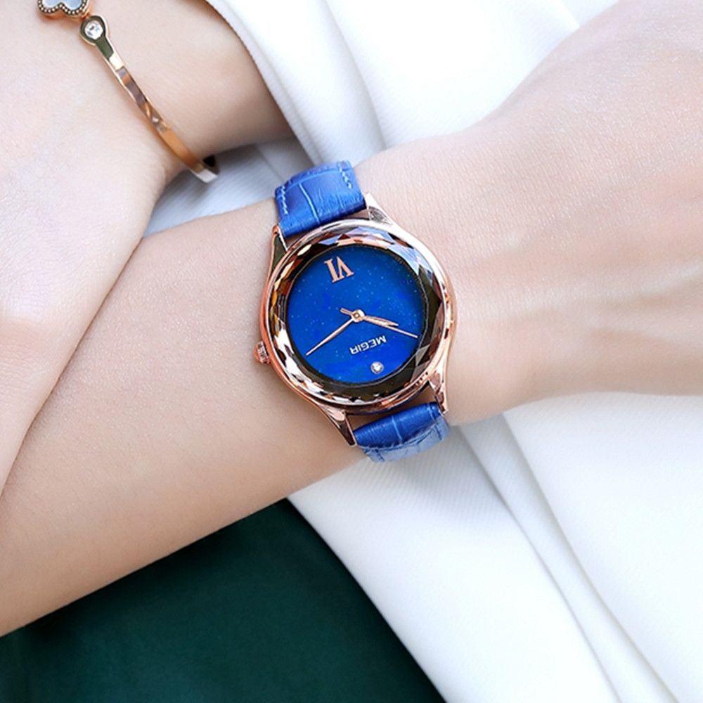 MEGIR 4208 women's quartz watch on the wrist, rose-gold faceted case with blue dial and blue leather strap