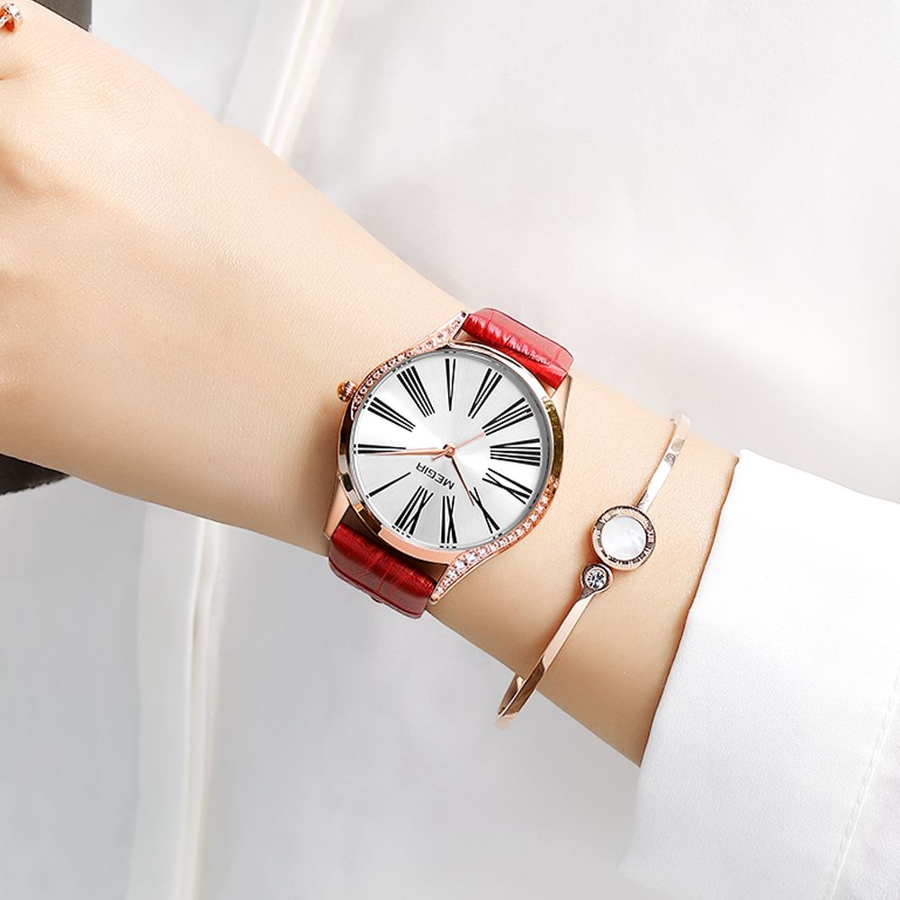 MEGIR 4212 women's quartz watch on the wrist, rose-gold case with white Roman-numeral dial and red strap