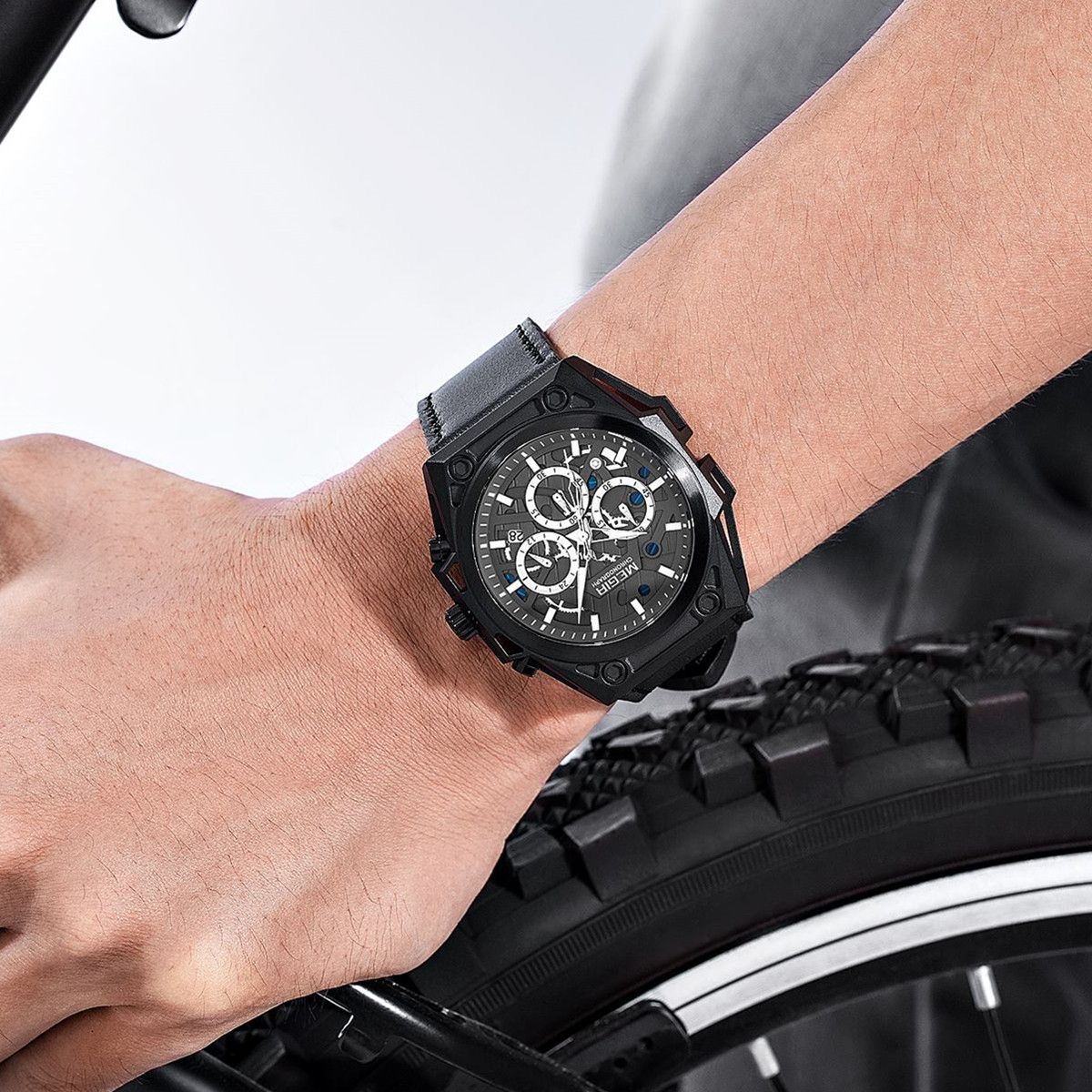 MEGIR 4220 men's chronograph watch on the wrist, black case with grey skeleton dial and black leather strap
