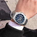 MEGIR 4220 men's chronograph watch on the wrist, silver case with blue skeleton dial and steel bracelet