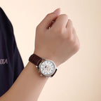 MEGIR 62046 moon-phase automatic watch on the wrist, silver and rose-gold case, white multi-dial face and brown strap