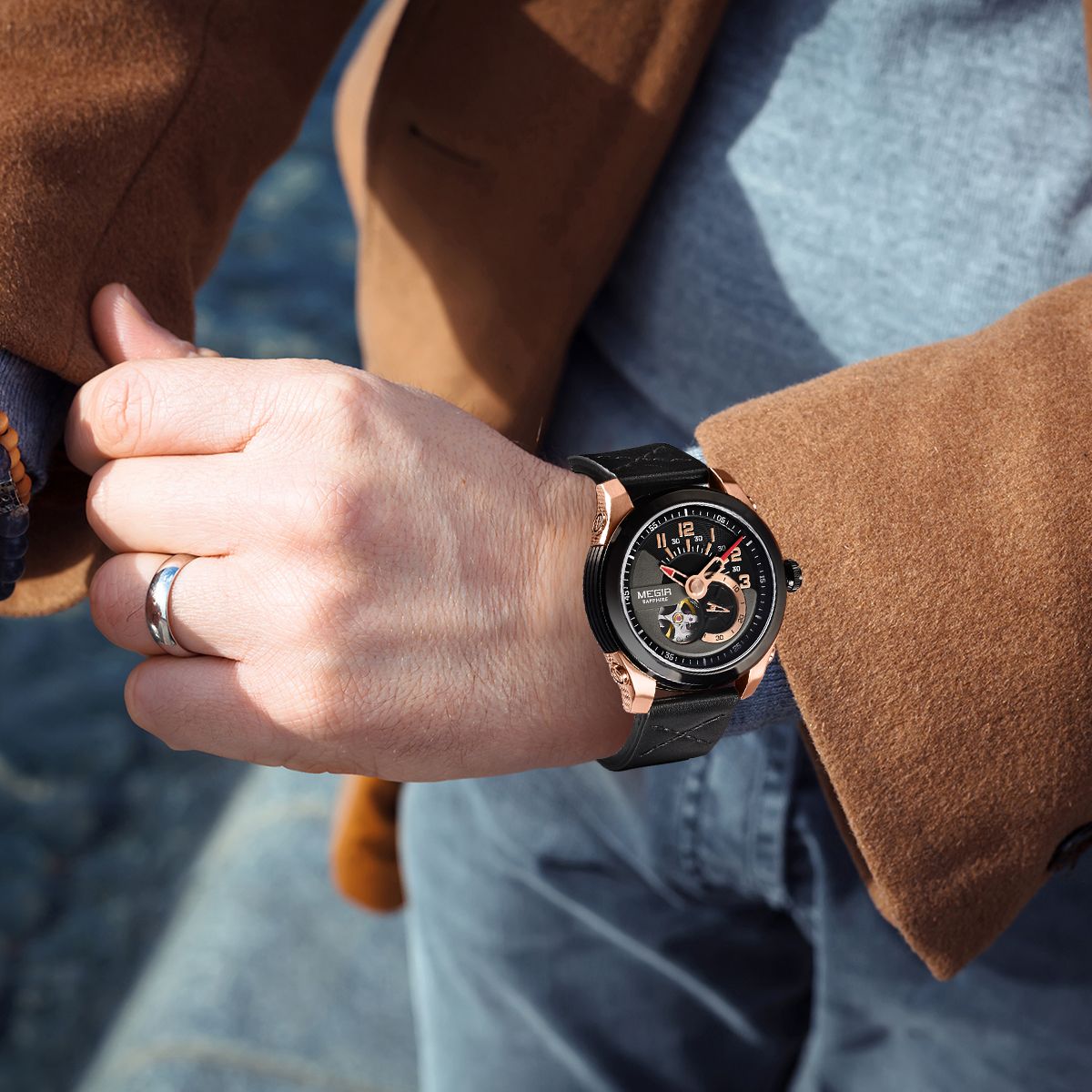 MEGIR 62050 automatic watch on the wrist, rose-gold and black case, black open-heart dial and black leather strap, outdoors