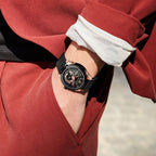 MEGIR 62050 automatic watch on the wrist, rose-gold and black case, black open-heart dial and black strap, red suit