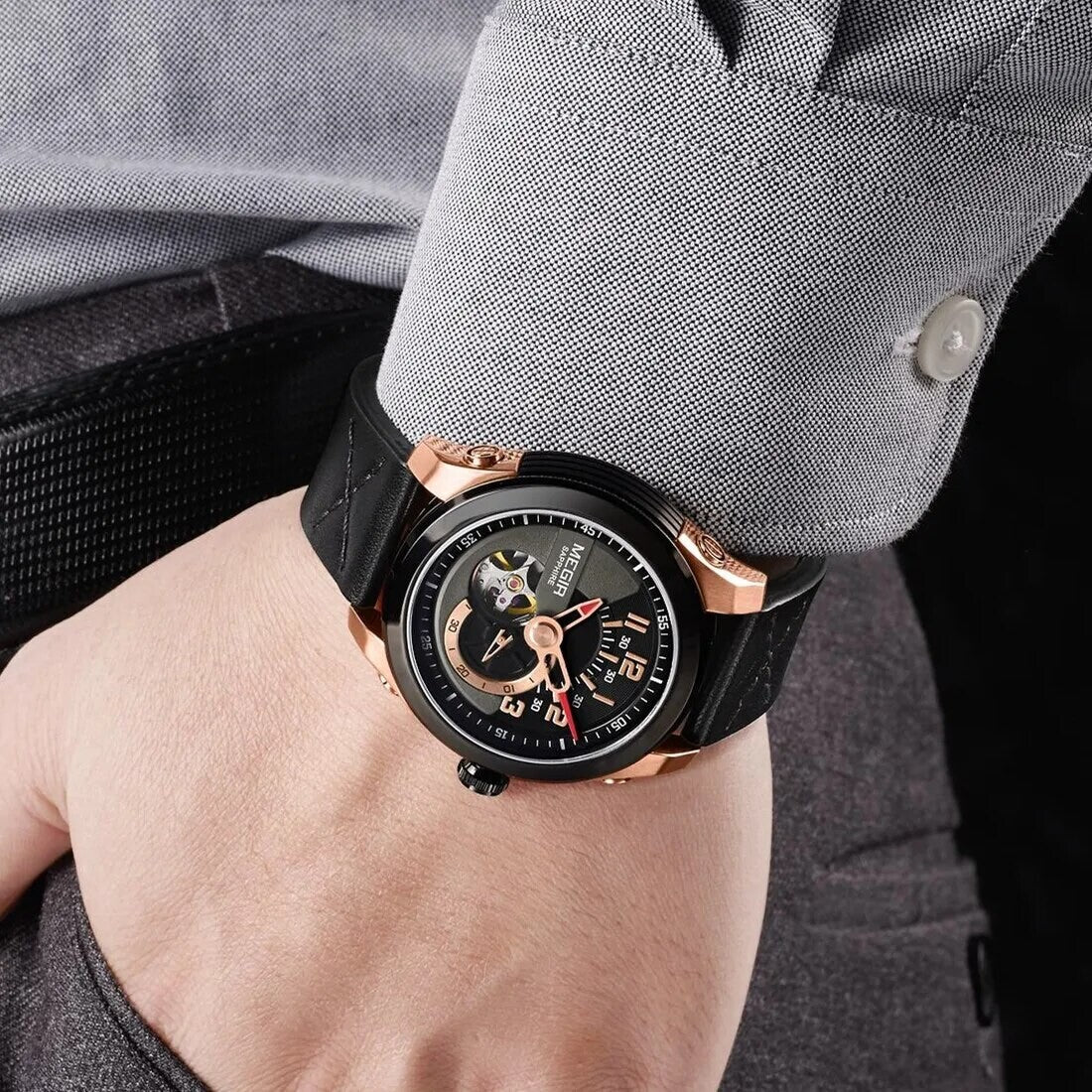 MEGIR 62050 automatic watch on the wrist, rose-gold and black case, black open-heart dial and black leather strap
