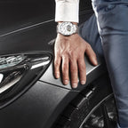 MEGIR 62052 skeleton automatic watch on the wrist, silver case and bracelet with white open-heart dial, by a car