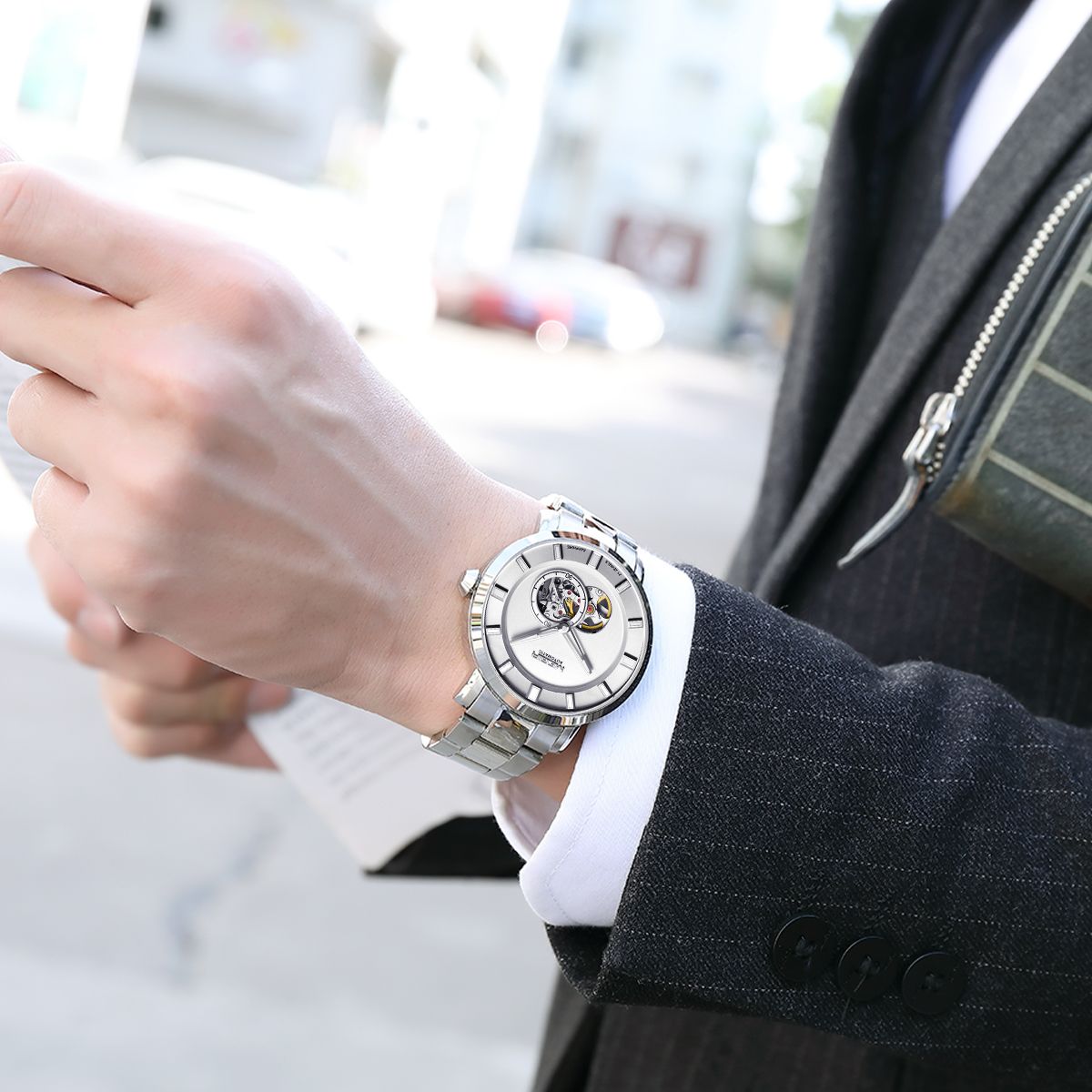 MEGIR 62052 skeleton automatic watch on the wrist, silver case and bracelet with white open-heart dial, with suit