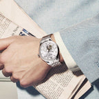 MEGIR 62053 automatic watch on the wrist, silver case and bracelet with white open-heart dial, with newspaper