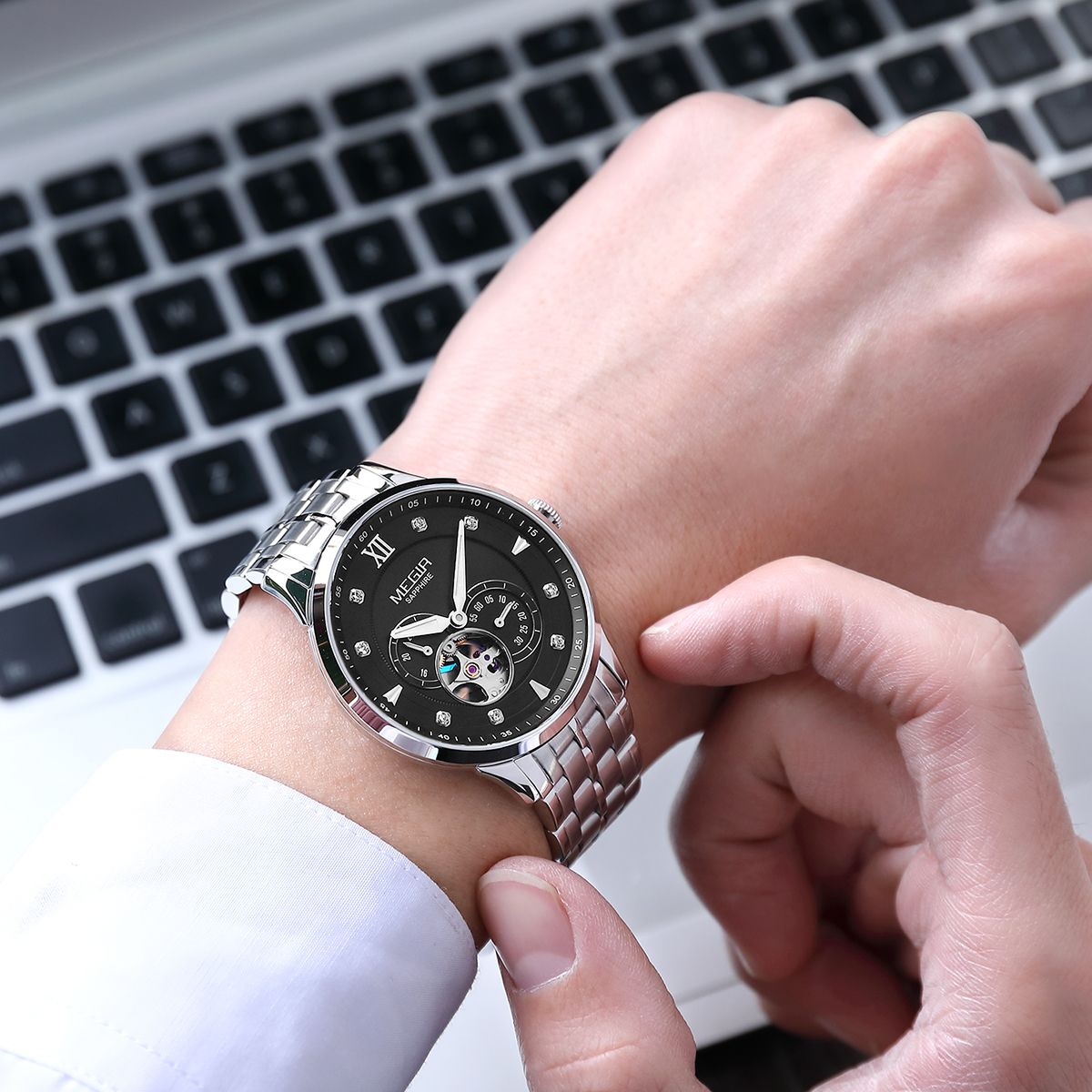 MEGIR 62053 automatic watch on the wrist, silver case and bracelet with black open-heart dial and sub-dial