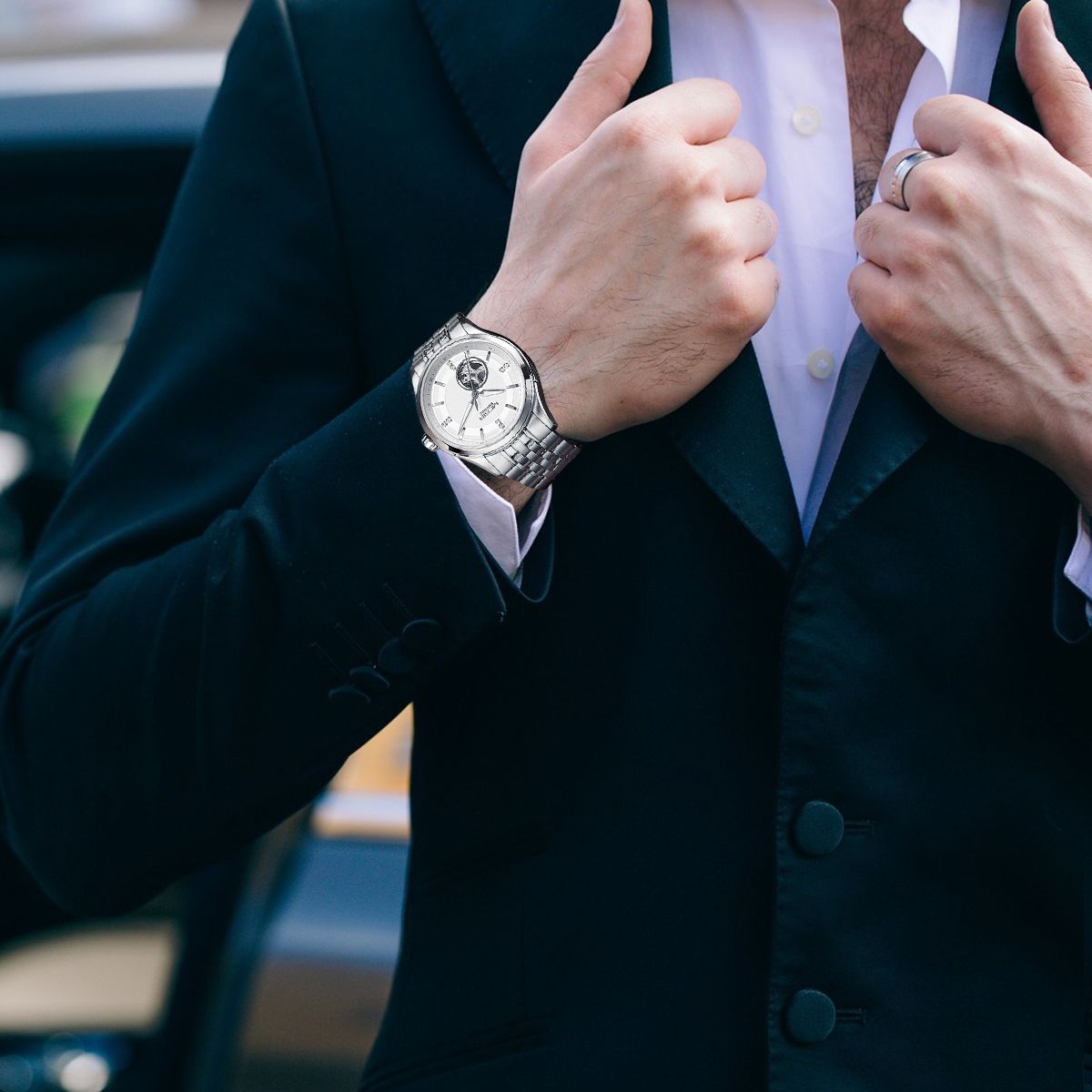 MEGIR 62055 automatic watch on the wrist, silver case and bracelet with white open-heart dial, outdoors