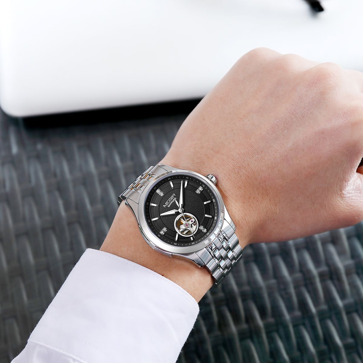 MEGIR 62055 automatic watch on the wrist, silver case and bracelet with black open-heart dial