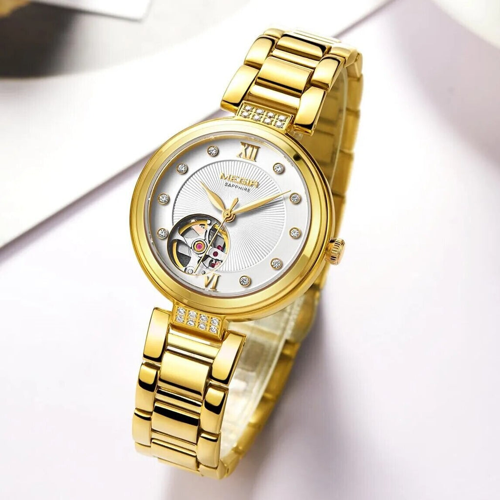 MEGIR 62060 women's skeleton automatic watch, gold-tone bracelet and white open-heart dial, angled view