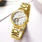 MEGIR 62060 women's skeleton automatic watch, gold-tone bracelet and white open-heart dial, angled view