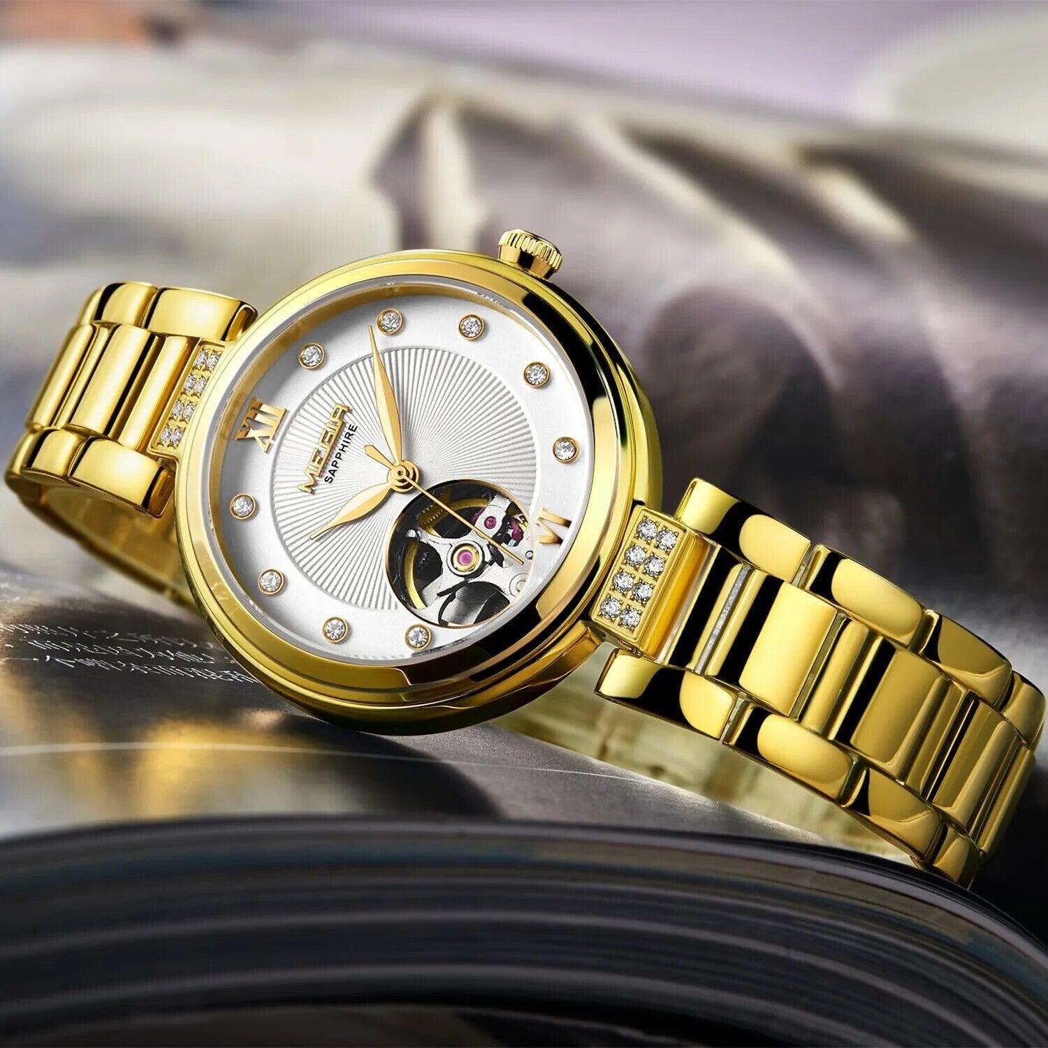 MEGIR 62060 women's skeleton automatic watch, gold-tone bracelet and white open-heart dial, styled three-quarter view