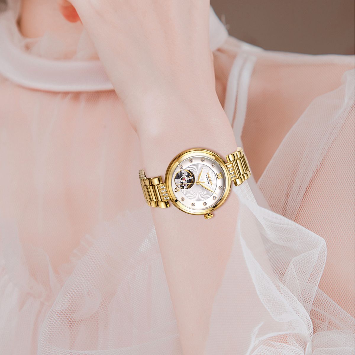 MEGIR 62060 skeleton automatic watch on the wrist, gold-tone bracelet and white open-heart dial with crystal markers