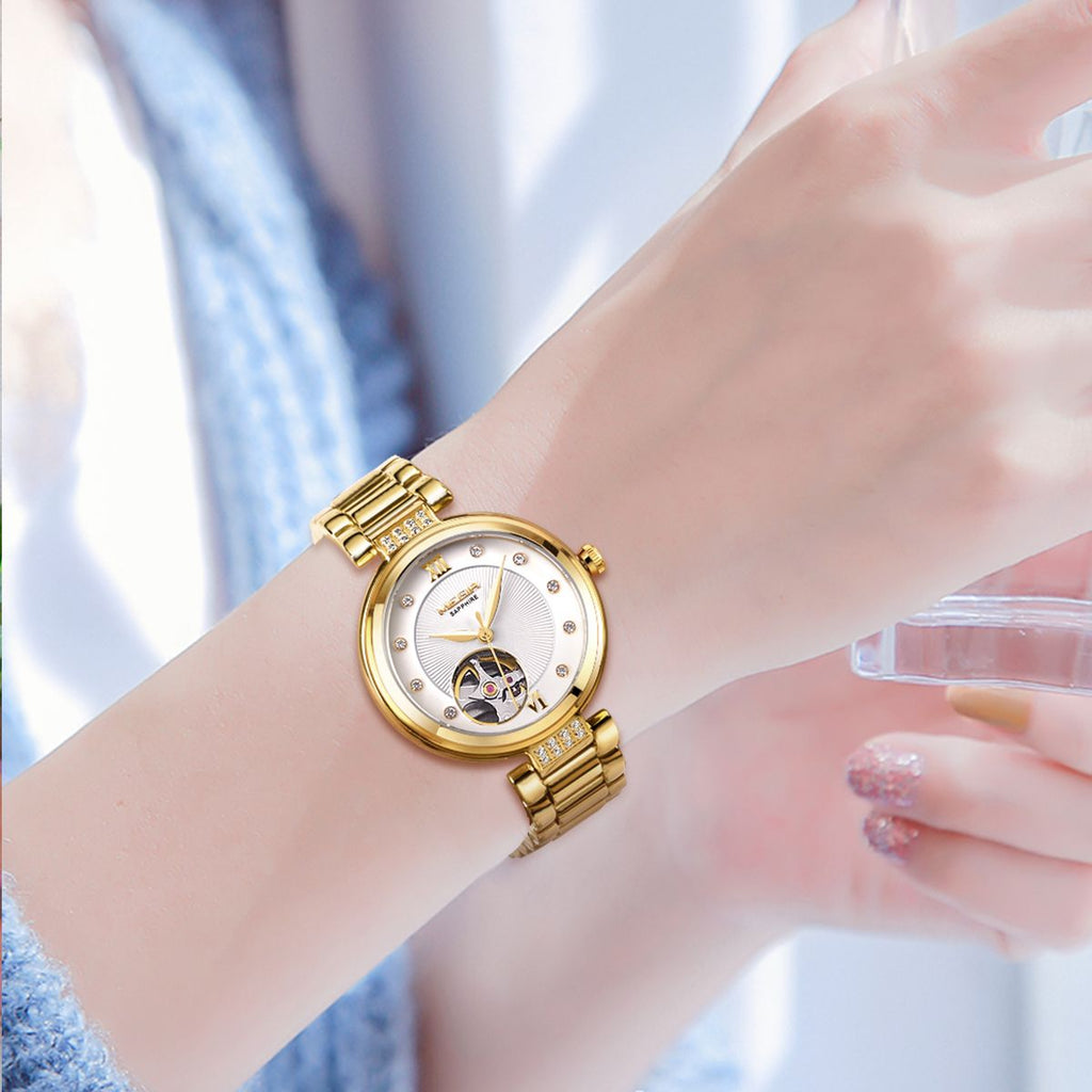 MEGIR 62060 skeleton automatic watch on the wrist, gold-tone bracelet and white open-heart dial