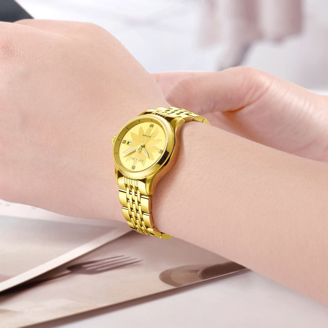 MEGIR 62061 automatic watch on the wrist, gold-tone steel bracelet and gold floral-engraved dial with date