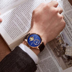 MEGIR 62070 automatic watch on the wrist, rose-gold case, blue open-heart dial and black leather strap