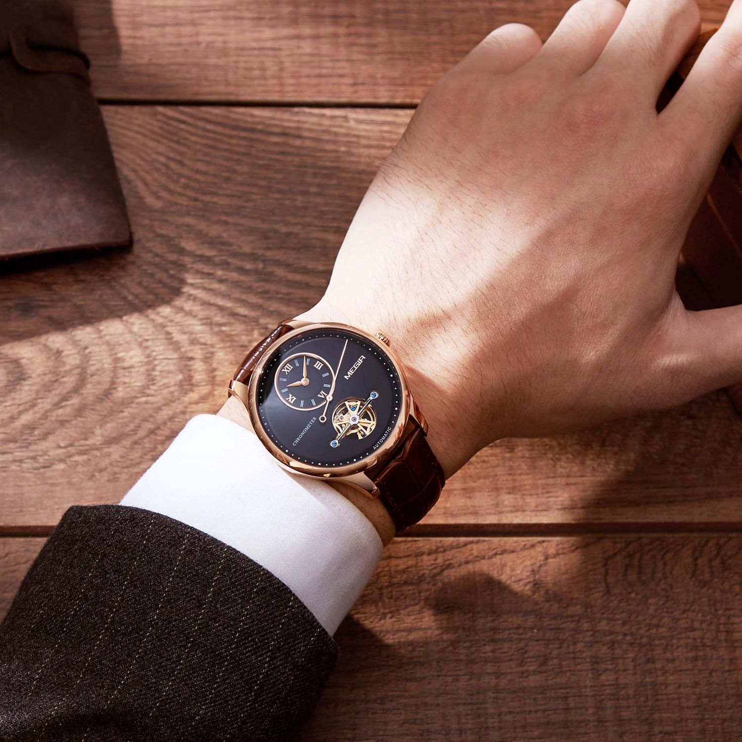 MEGIR 62070 automatic watch on the wrist, rose-gold case, black open-heart dial and brown leather strap