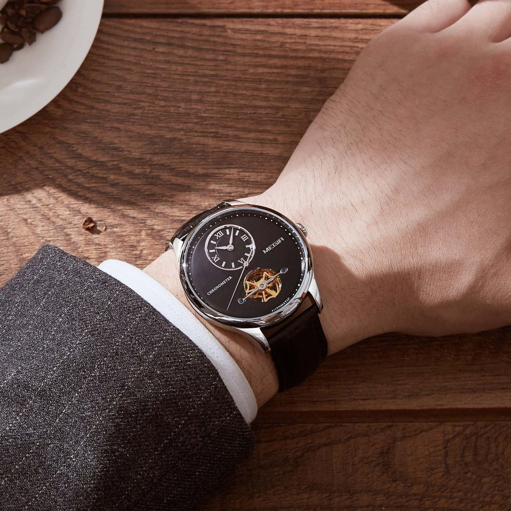 MEGIR 62070 automatic watch on the wrist, silver case, black open-heart dial and black leather strap