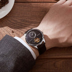 MEGIR 62070 automatic watch on the wrist, silver case, black open-heart dial and black leather strap