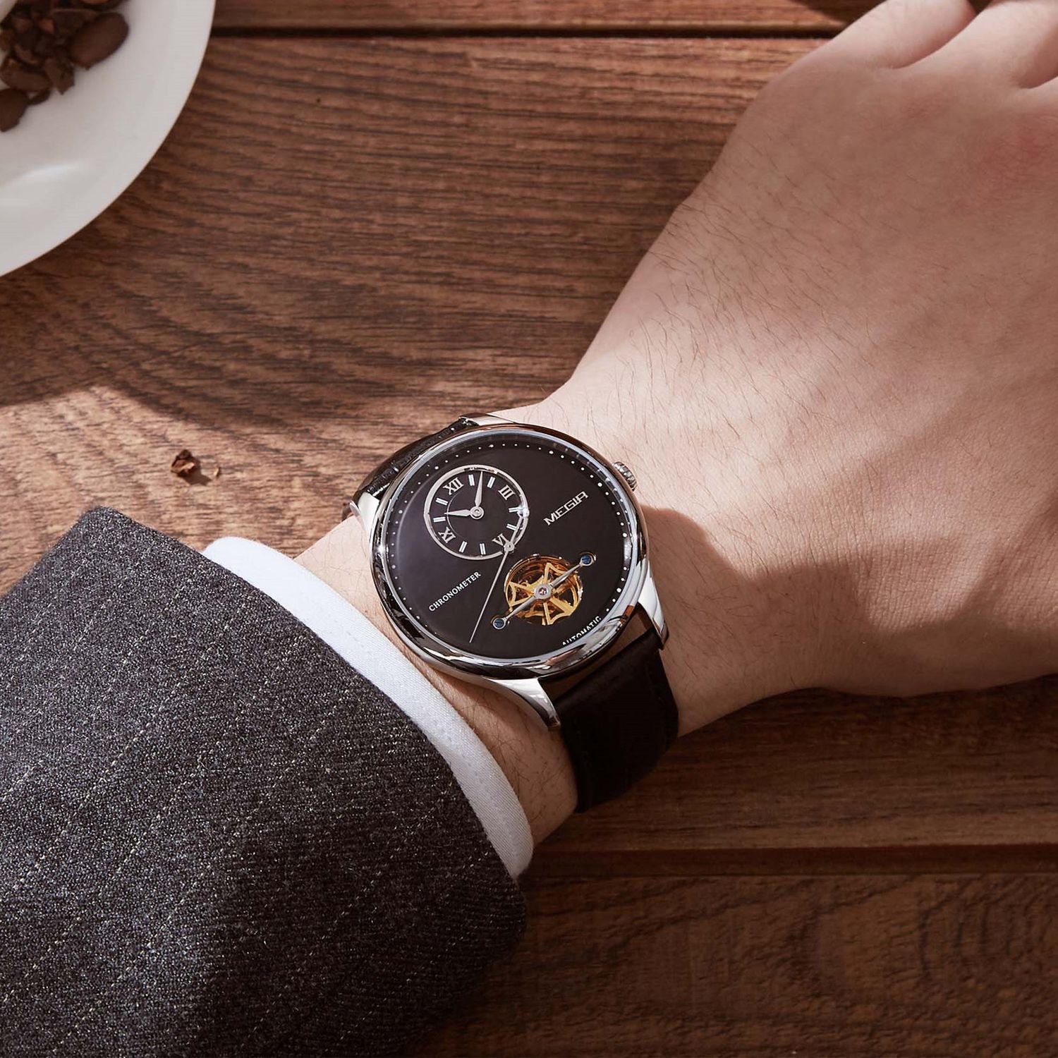 MEGIR 62070 automatic watch on the wrist, silver case, black open-heart dial and black leather strap