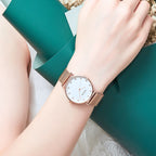 MEGIR 7001 quartz watch on the wrist, rose-gold mesh bracelet and white crystal-marker dial, resting on the arm