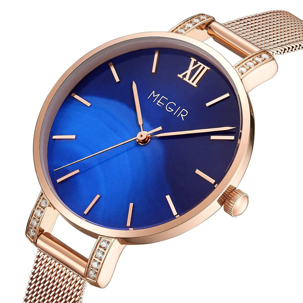 MEGIR 7002 women's quartz watch, rose-gold mesh bracelet and blue dial with crystal-set lugs, angled view