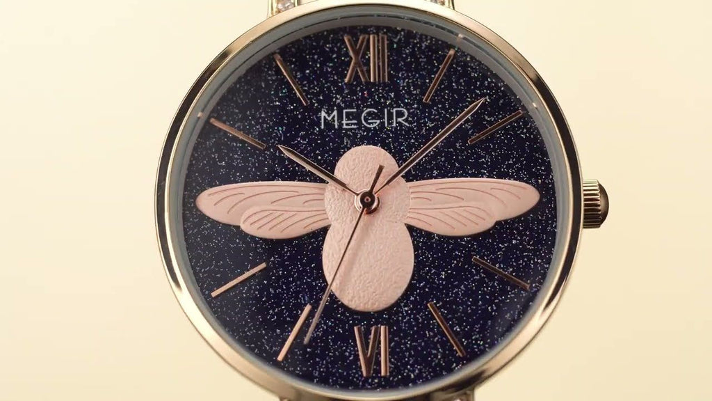 MEGIR 7009 women's quartz watch dial close-up, dark-blue starry face with rose-gold bee and Roman numerals