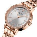 MEGIR 7012 women's quartz watch, rose-gold case, silver-white dial and crystal-set rose-gold bracelet, angled view