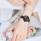 MEGIR 7014 quartz watch on the wrist, black case, black Roman-numeral dial and black mesh bracelet