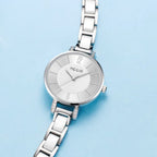MEGIR 7016 women's quartz watch, silver case, silver-white dial and white link bracelet, styled on blue background